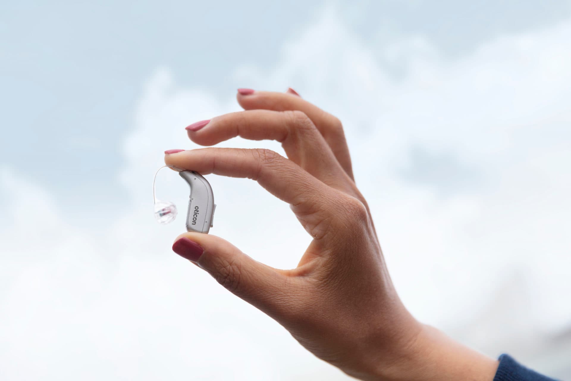 Modern hearing aid in hand